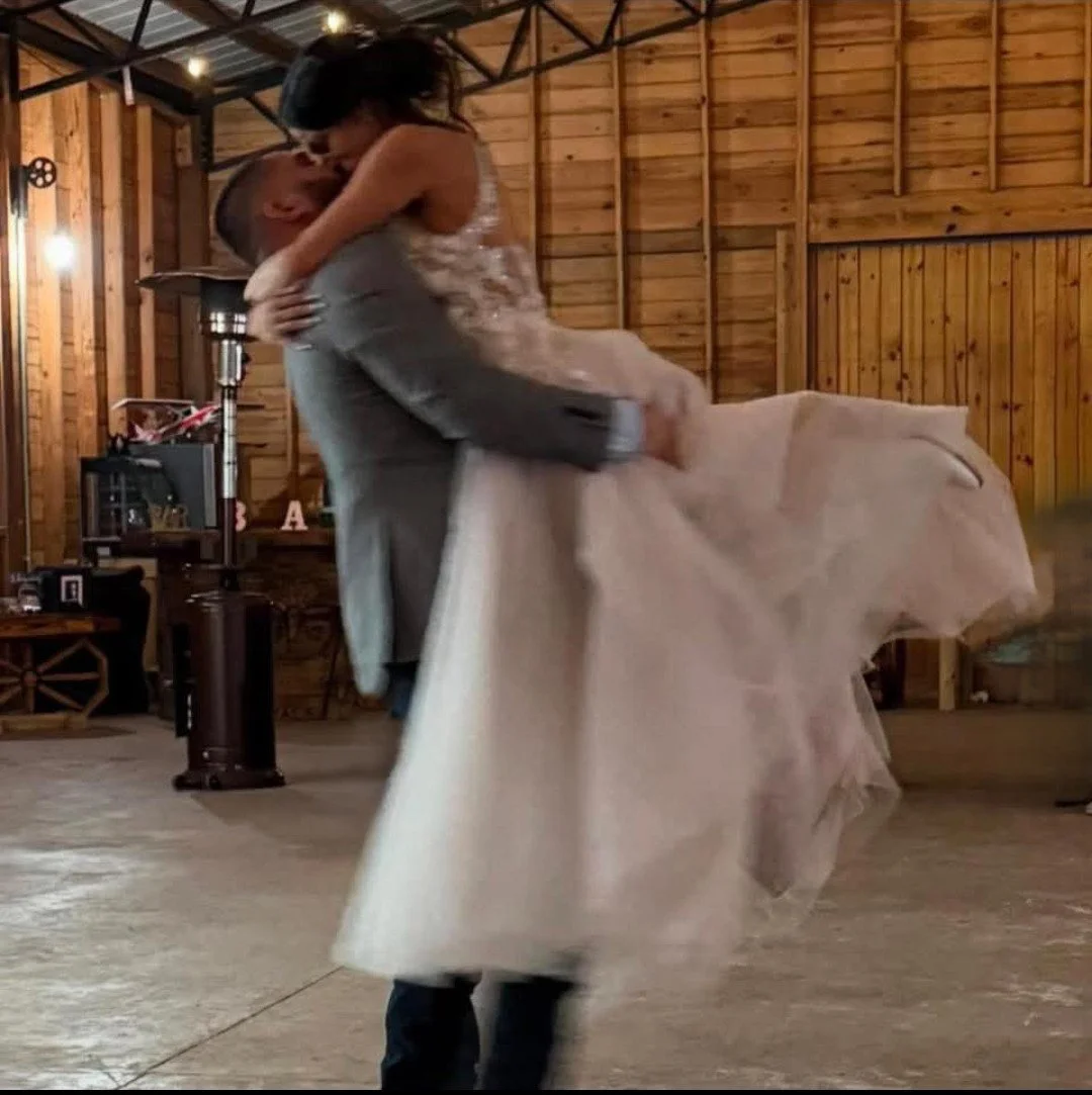 Groom lifting bride on the dance floor at a wedding reception